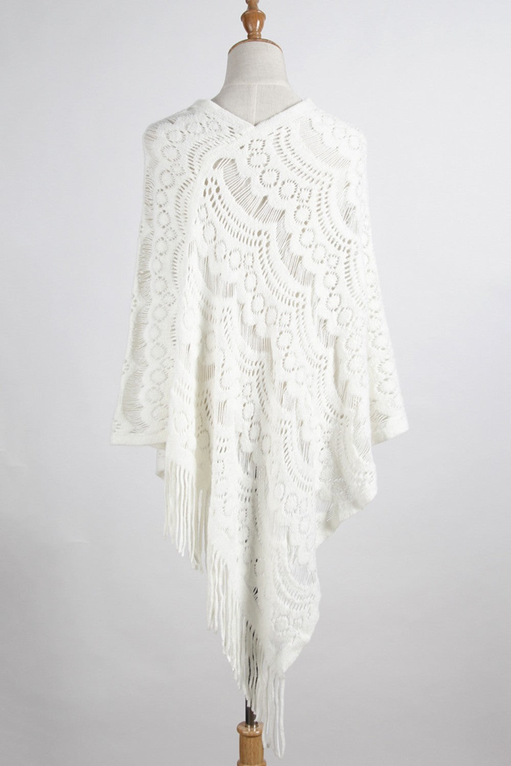 Lightweight white boho poncho with intricate knit design
