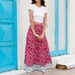 Closeup of the vibrant floral pattern on a lightweight woven maxi skirt.
