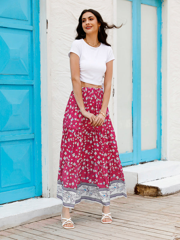 Closeup of the vibrant floral pattern on a lightweight woven maxi skirt.
