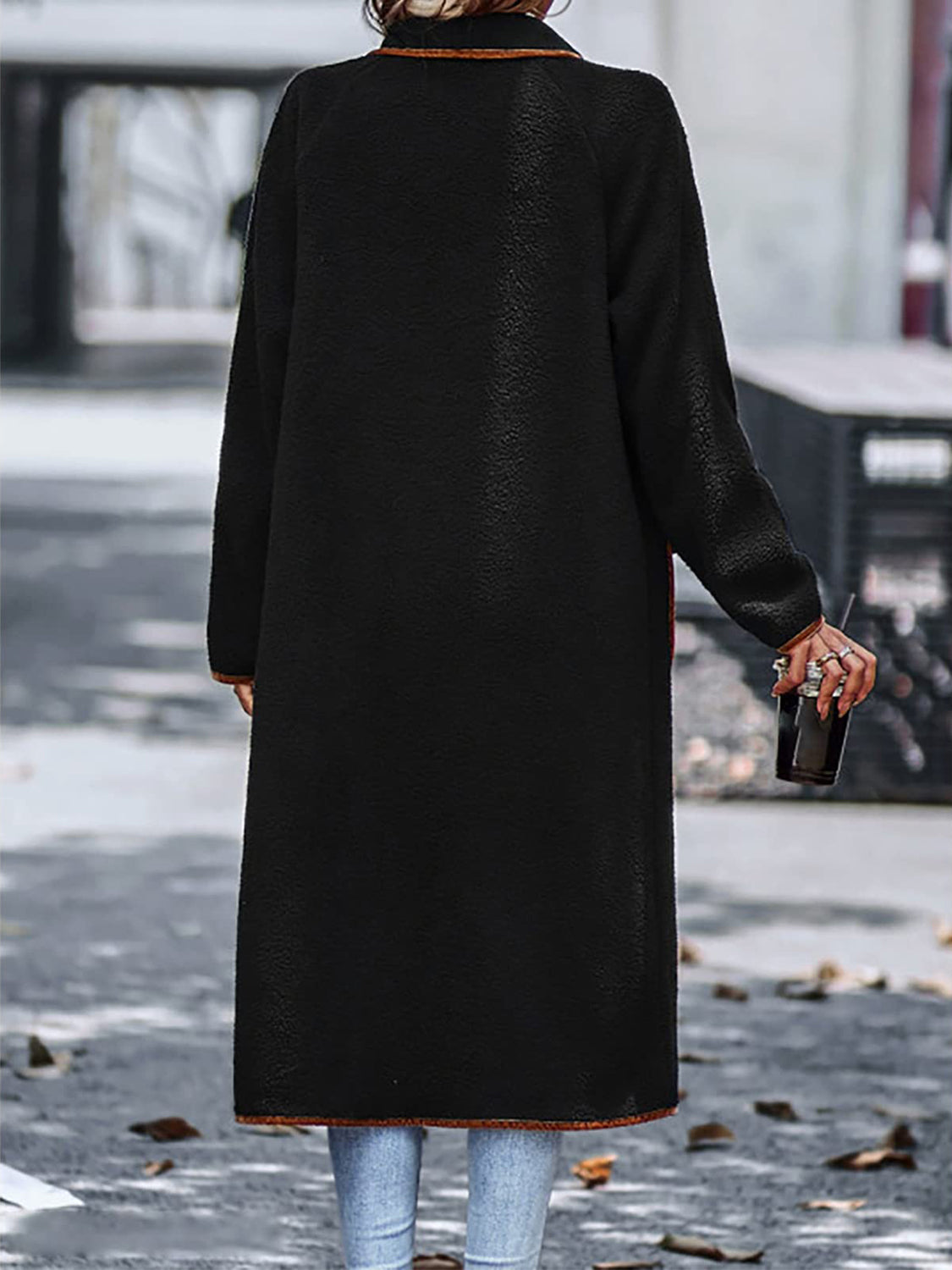 Versatile black long sherpa coat with elegant contrast trim.
