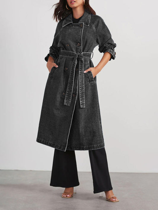 Closeup of belt detail on black denim trench coat for women
