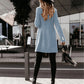 Full-length shot of a long-sleeve blue woolen coat styled for casual wear.
