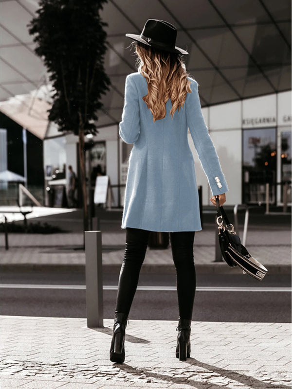 Full-length shot of a long-sleeve blue woolen coat styled for casual wear.
