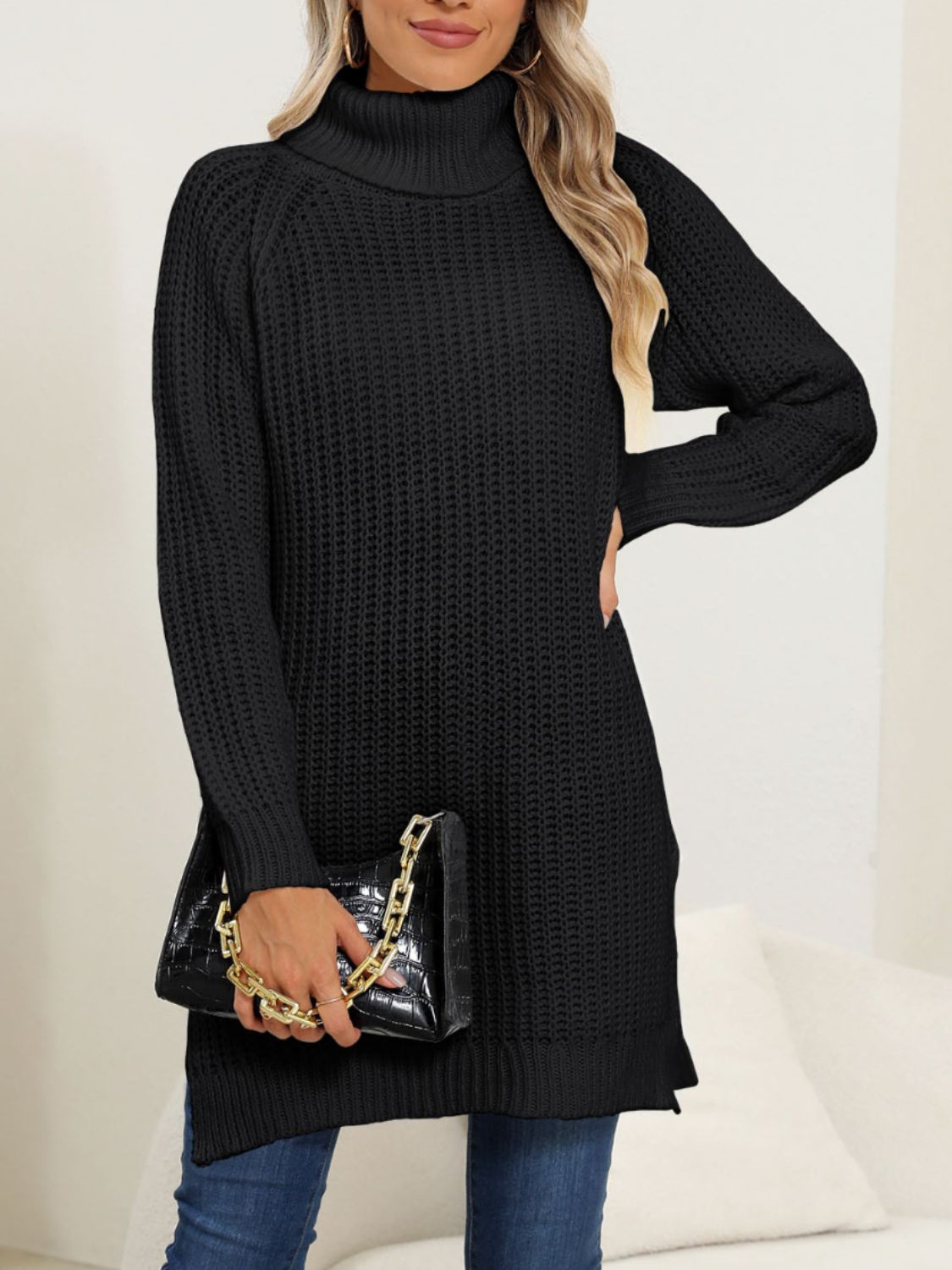 Woman wearing a cozy black turtleneck slit sweater.
