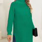 Warm green turtleneck sweater with chic side slits for casual wear.
