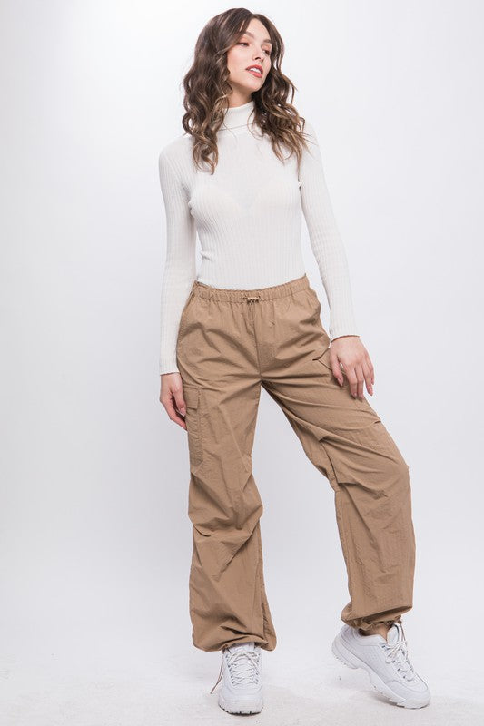 Front view of loose-fit cargo pants in khaki with an elastic waistband.
