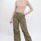 Front view of loose-fit cargo pants in olive with adjustable elastic waist.
