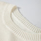 Loose-fitting ivory snowflake sweater with a flattering tunic length, great for layering over leggings in winter.