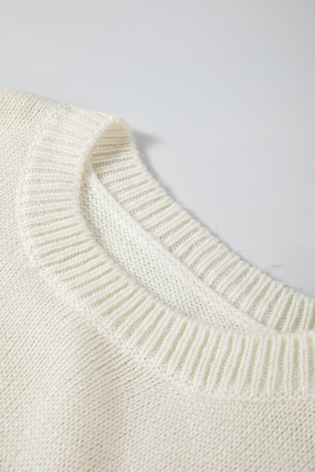 Loose-fitting ivory snowflake sweater with a flattering tunic length, great for layering over leggings in winter.