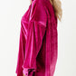 Elegant magenta velvet shirt styled for plus-size fall fashion.





