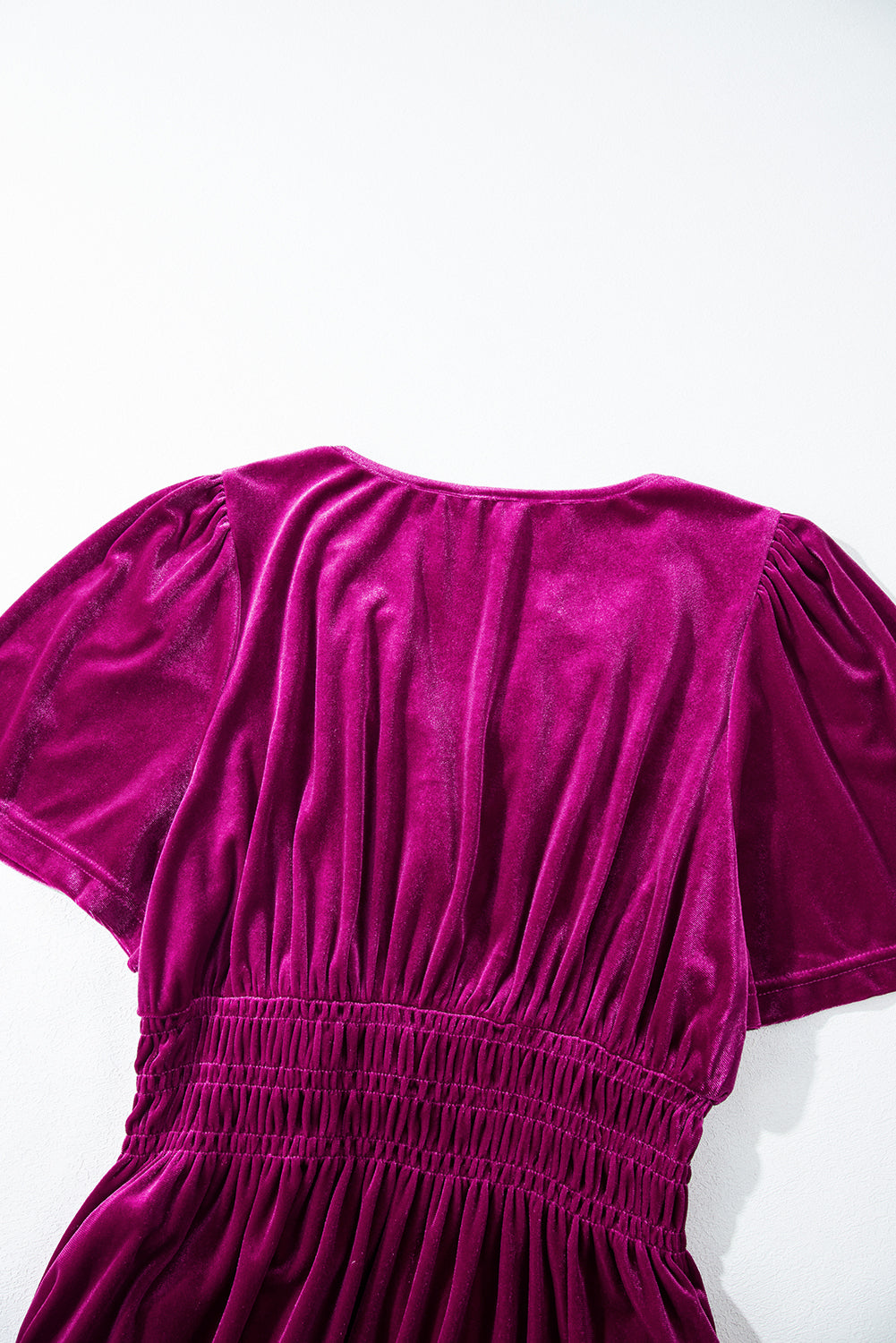 Luxurious magenta velvet maxi dress featuring a shirred waist and pockets
