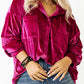 Plus-size model showcasing a magenta velvet shirt with a drop shoulder design.
