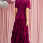 Back view of magenta velvet tiered maxi dress with short sleeves
