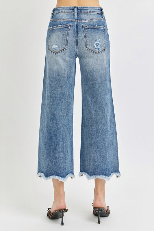 RISEN medium-wash cropped flare jeans featuring a frayed hem and high-rise waist
