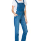 Side view of medium wash denim overalls showcasing functional pockets.
