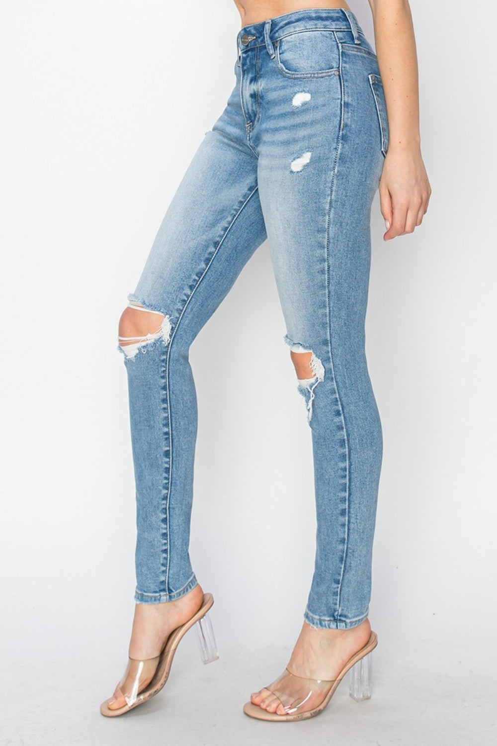 Medium-wash skinny jeans with distressed knees for an edgy, laid-back look
