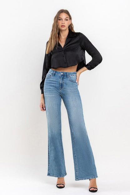 Wide-leg high-rise jeans styled with black heels for a chic look
