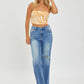 Medium wash high-rise wide leg jeans with distressed finish and frayed hem