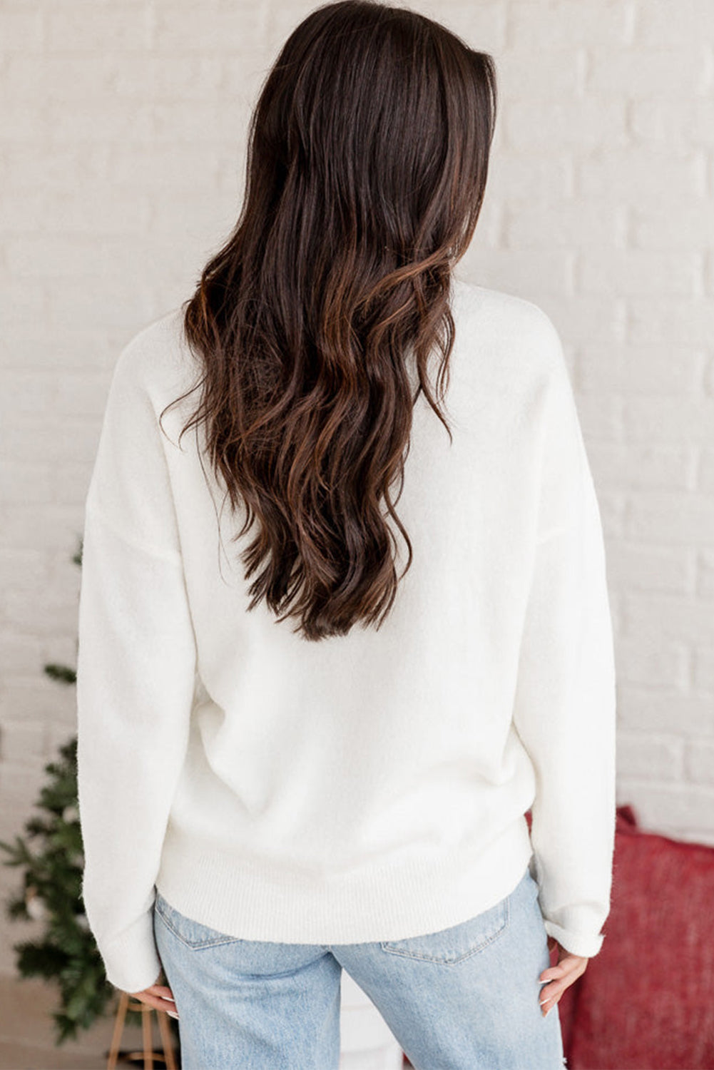 Back of the "Merry & Bright" white sweater with tinsel accents, great for casual or festive winter events.