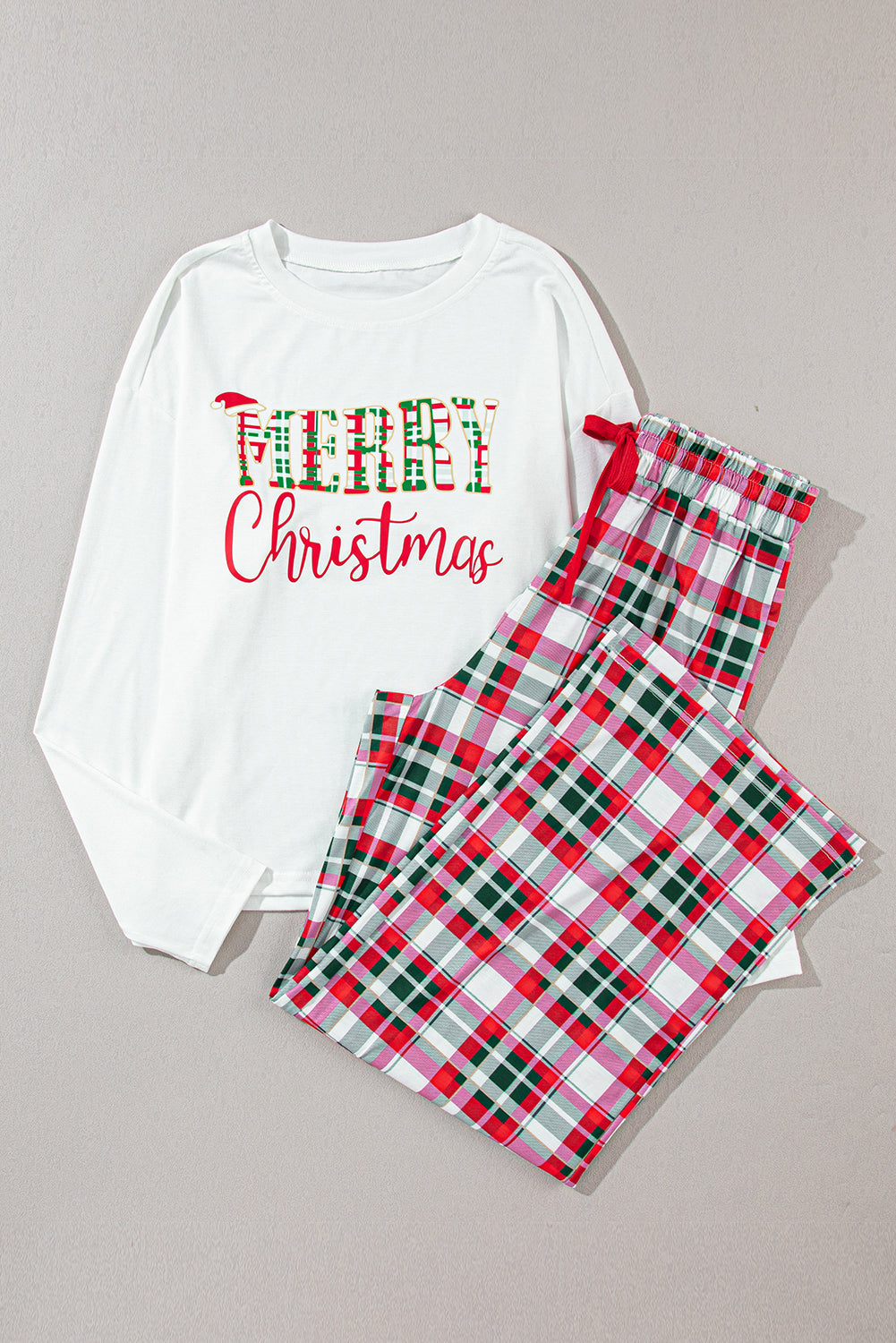 Two-piece Christmas pajama set featuring plaid pants and a "Merry Christmas" top.
