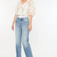 Light-wash mid rise jeans with frayed hem for casual style.