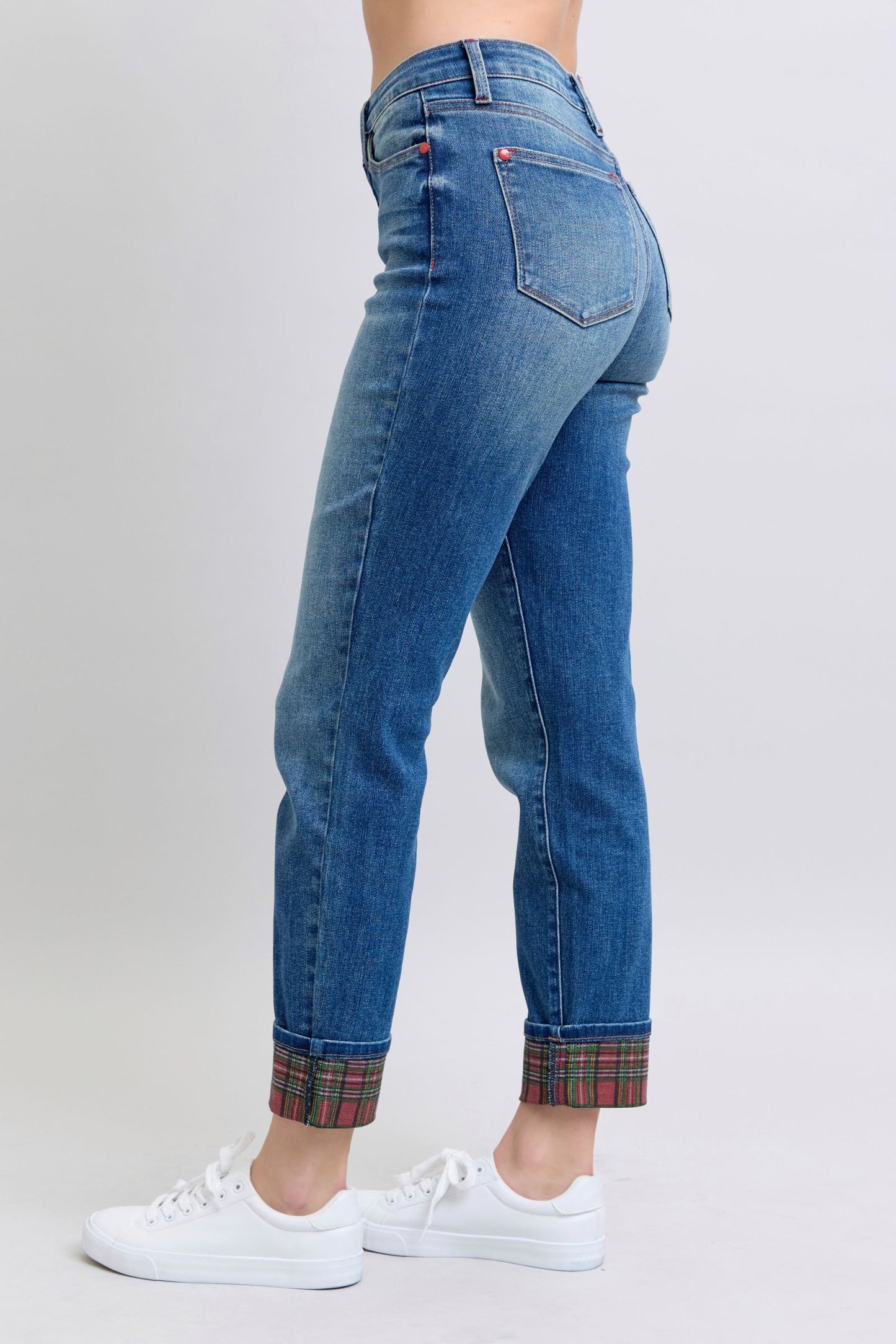 Women’s mid-waist denim with plaid accents for casual wear.
