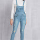 Women’s mid-waist light washed denim overalls featuring distressed accents and slight stretch.
