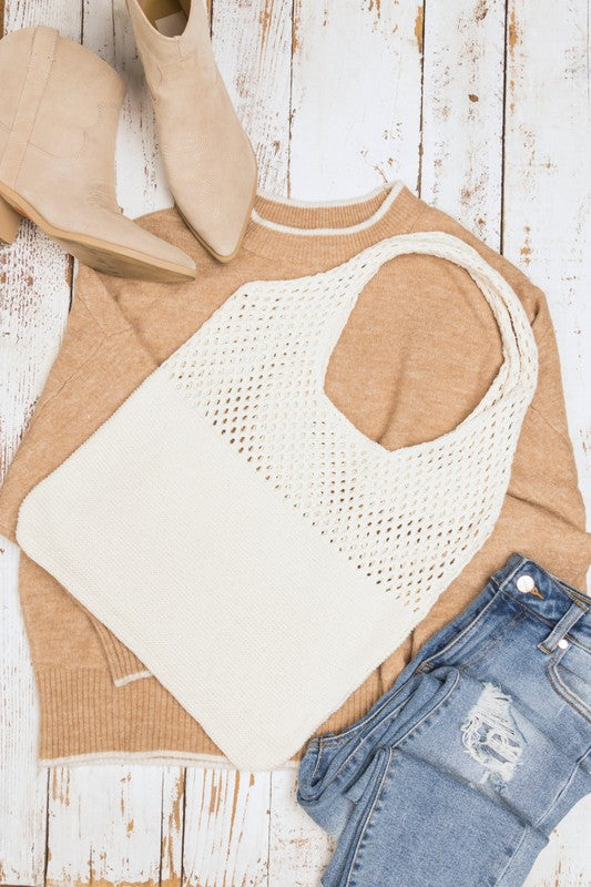 Elegant cream knit hobo tote, perfect for shopping or casual use.
