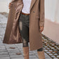 Mocha overcoat featuring flap pockets and a sleek tailored silhouette.
