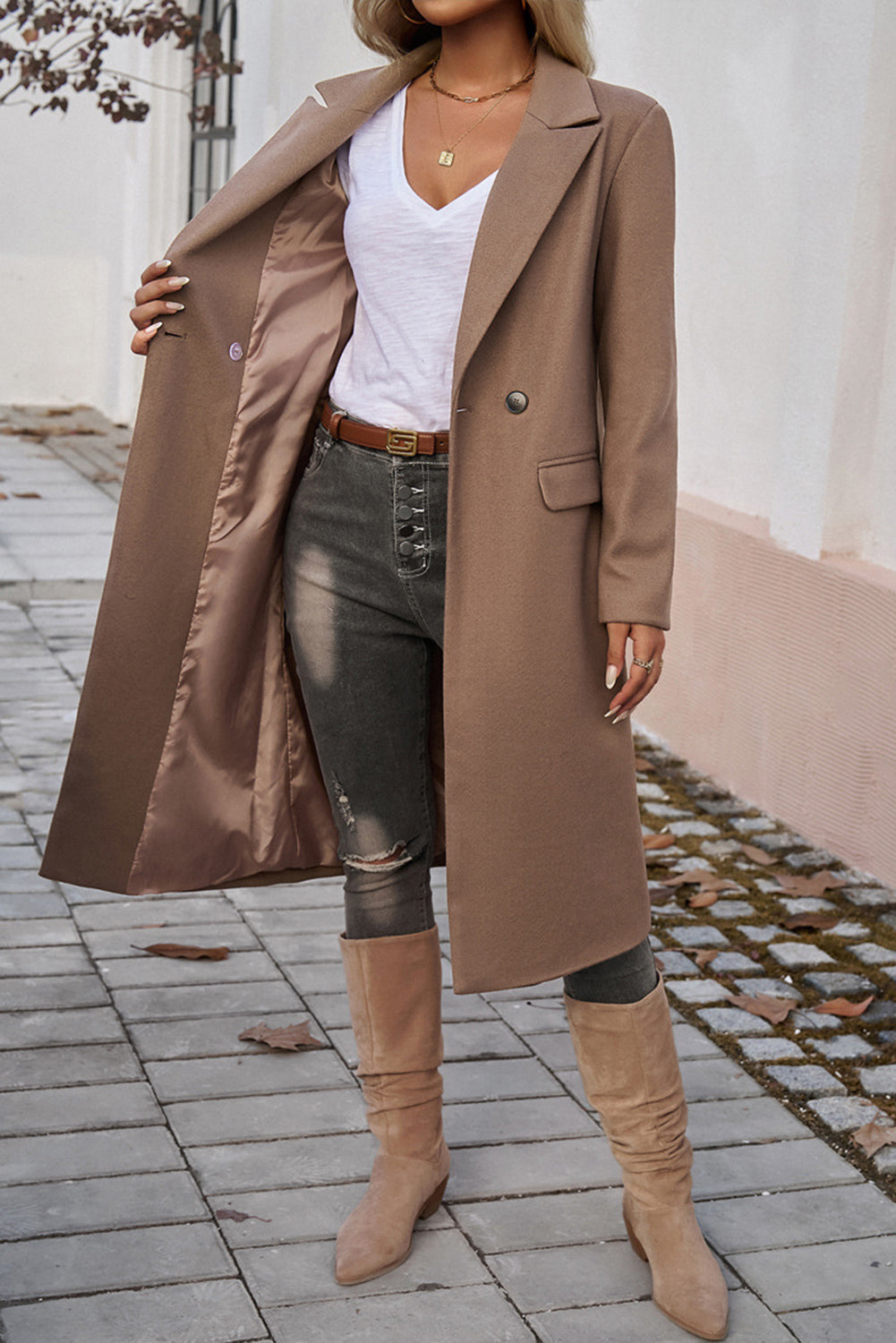 Mocha overcoat featuring flap pockets and a sleek tailored silhouette.
