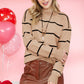 Detailed shot of soft knit fabric in mocha striped sweater.
