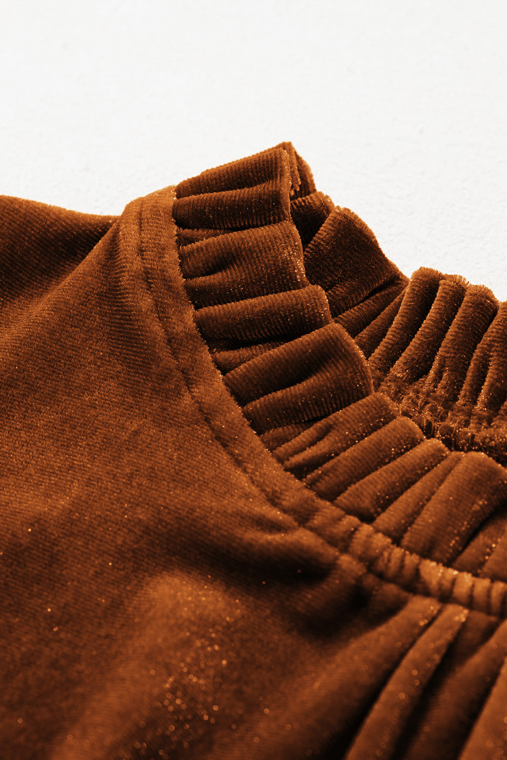 Close-up showcasing the soft, plush texture of the mocha velvet fabric.
