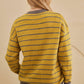 Vintage-style mustard yellow sweater featuring white flowers and gray stripes | boho aesthetic
