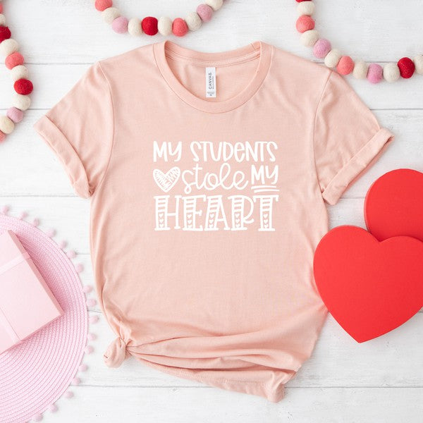 Close-up of pink "My Students Stole My Heart" graphic tee