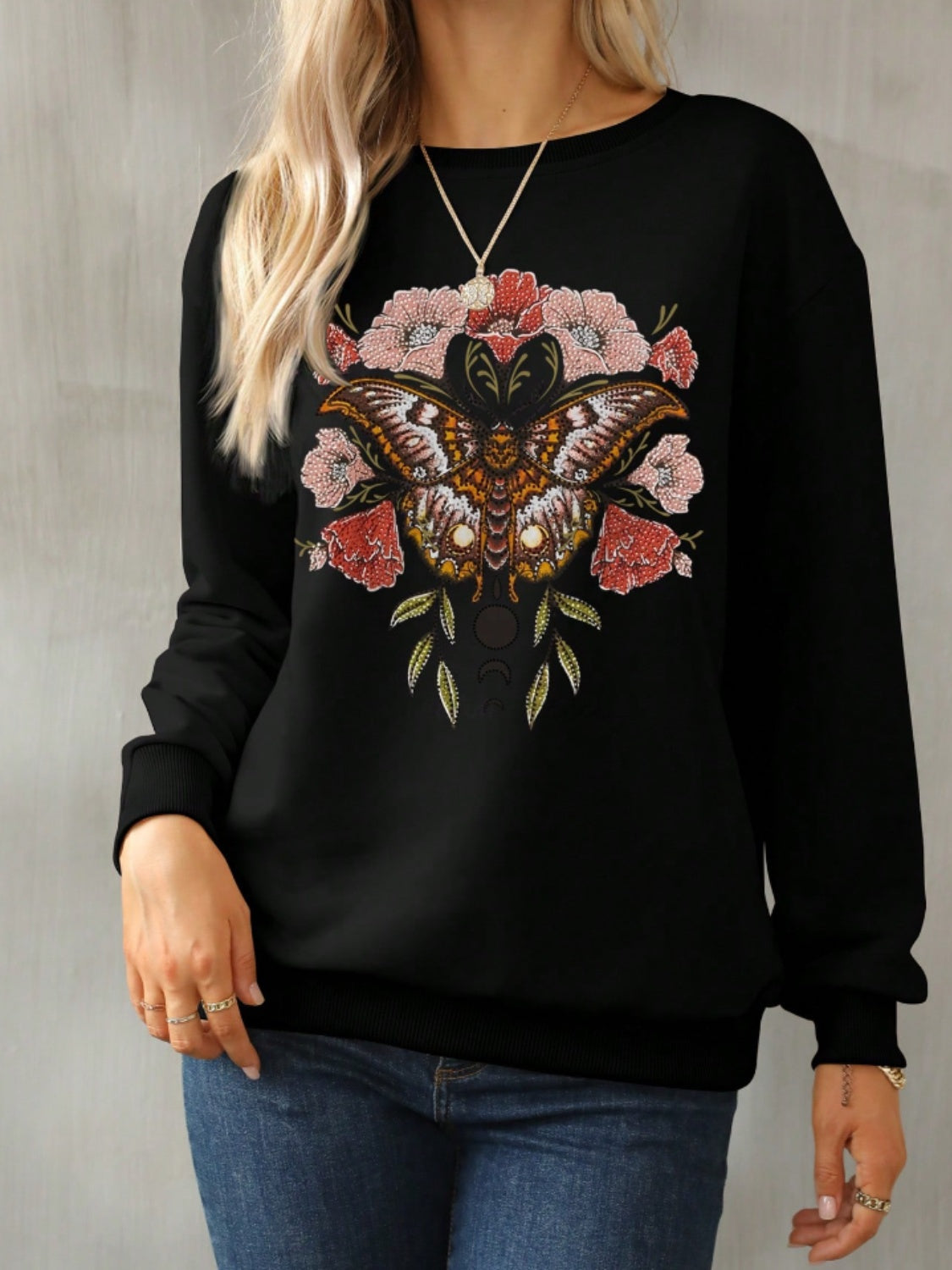 nature-inspired butterfly graphic on black sweatshirt
