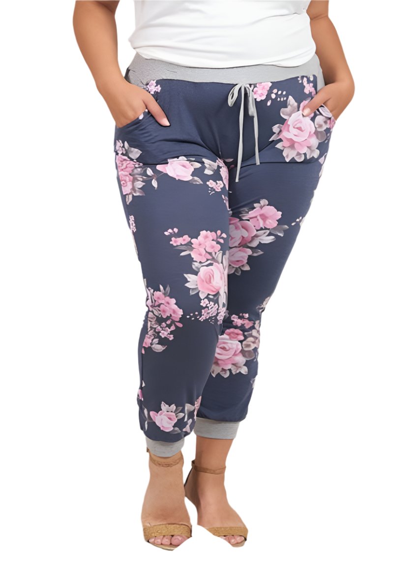 Woman wearing navy plus size sweatpants with pink floral design
