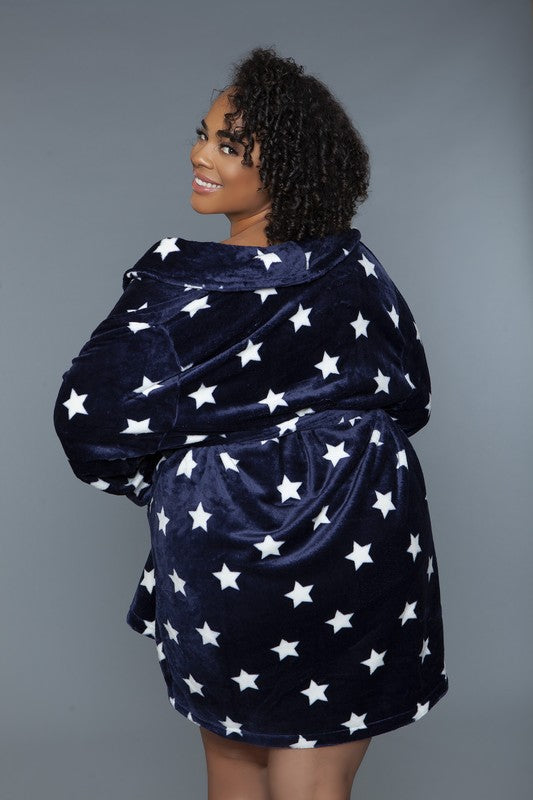 Woman wearing a belted navy plush robe with a star pattern, styled for loungewear.
