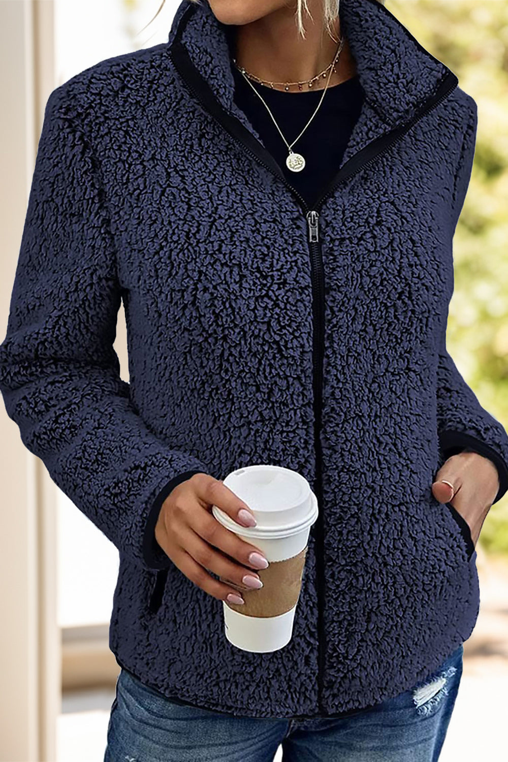 Navy fleece sherpa jacket for women, featuring a full zipper and relaxed fit.
