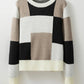 Cozy knit sweater featuring a chic color block pattern in neutral tones.
