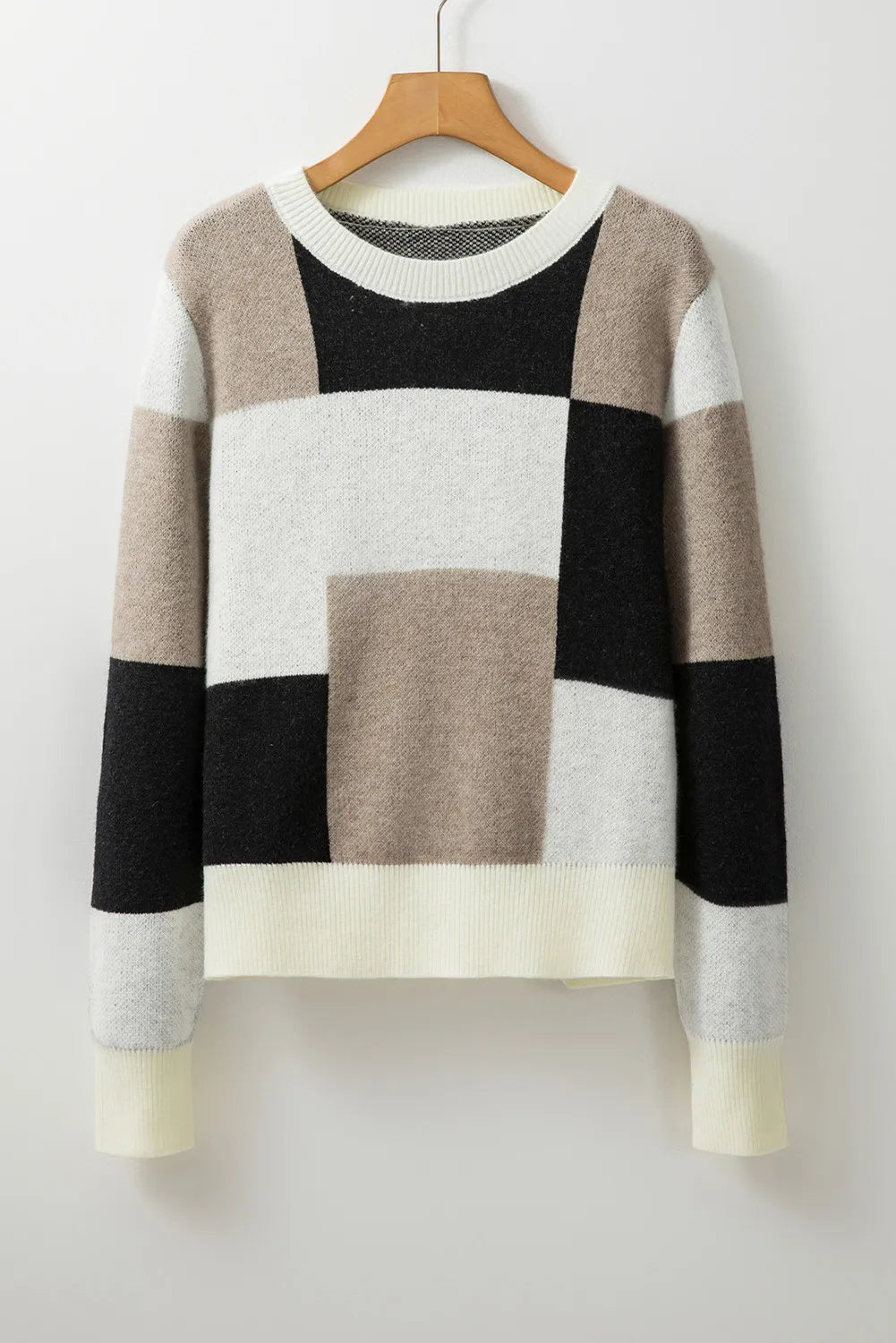 Cozy knit sweater featuring a chic color block pattern in neutral tones.
