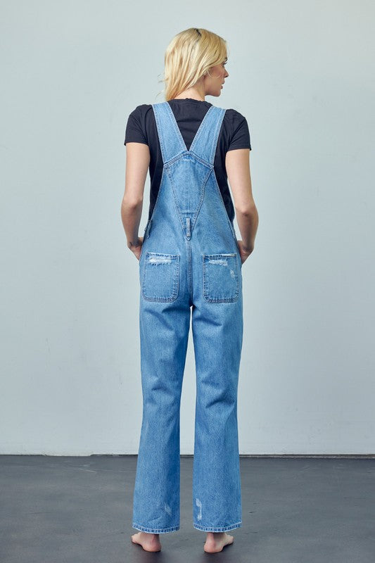 Casual medium wash denim overalls with distressed knee details and high waist.
