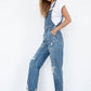 Relaxed-fit slim straight denim overalls with side button closure for women.
