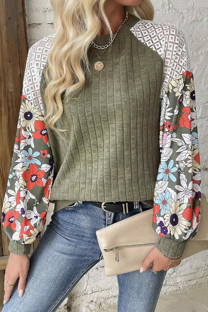 Olive top with lace shoulder details and floral print sleeves, styled casually