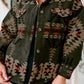 Women’s pocketed jacket in olive with geometric print, close-up
