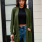 Olive drape cardigan with an open front design, styled over a black top.