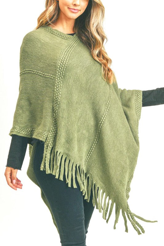 Olive green fringed poncho, a versatile piece for adding a touch of style and warmth to any casual look.