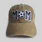 Front view of the olive Soccer Mom Cap with an embroidered "MOM" and soccer ball design.