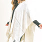 Ivory fringe shawl adding warmth and style to fall outfits.
