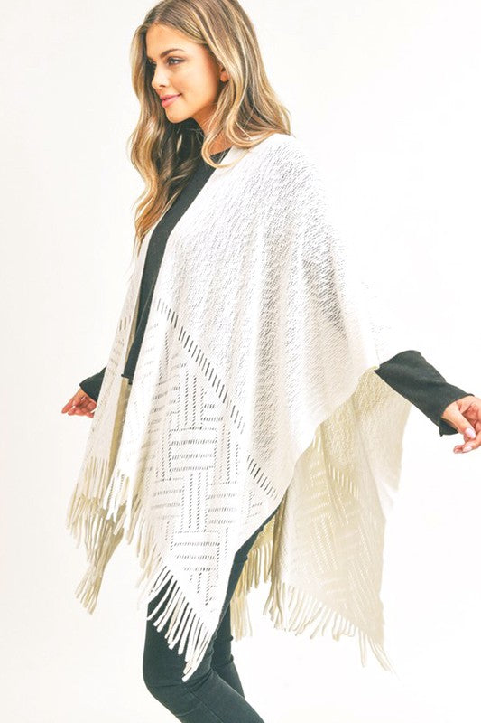 Ivory fringe shawl adding warmth and style to fall outfits.
