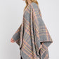 Gray plaid shawl with classic pattern and orange trim for fall style.
